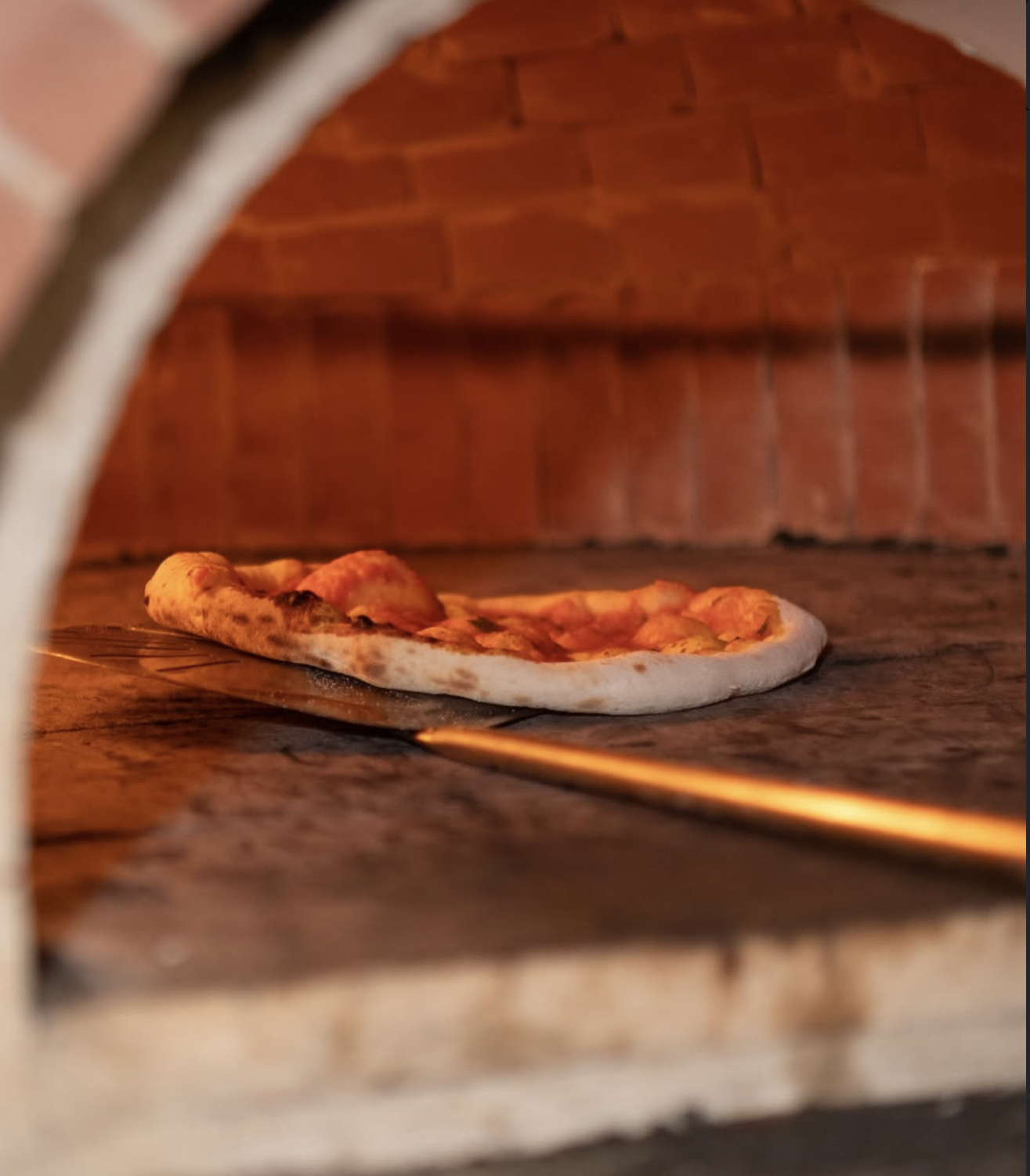 Pizza baking in the wood oven at December9 Agia Anna